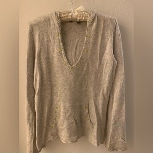 Lightweight cashmere sweater w hood and front pocket.